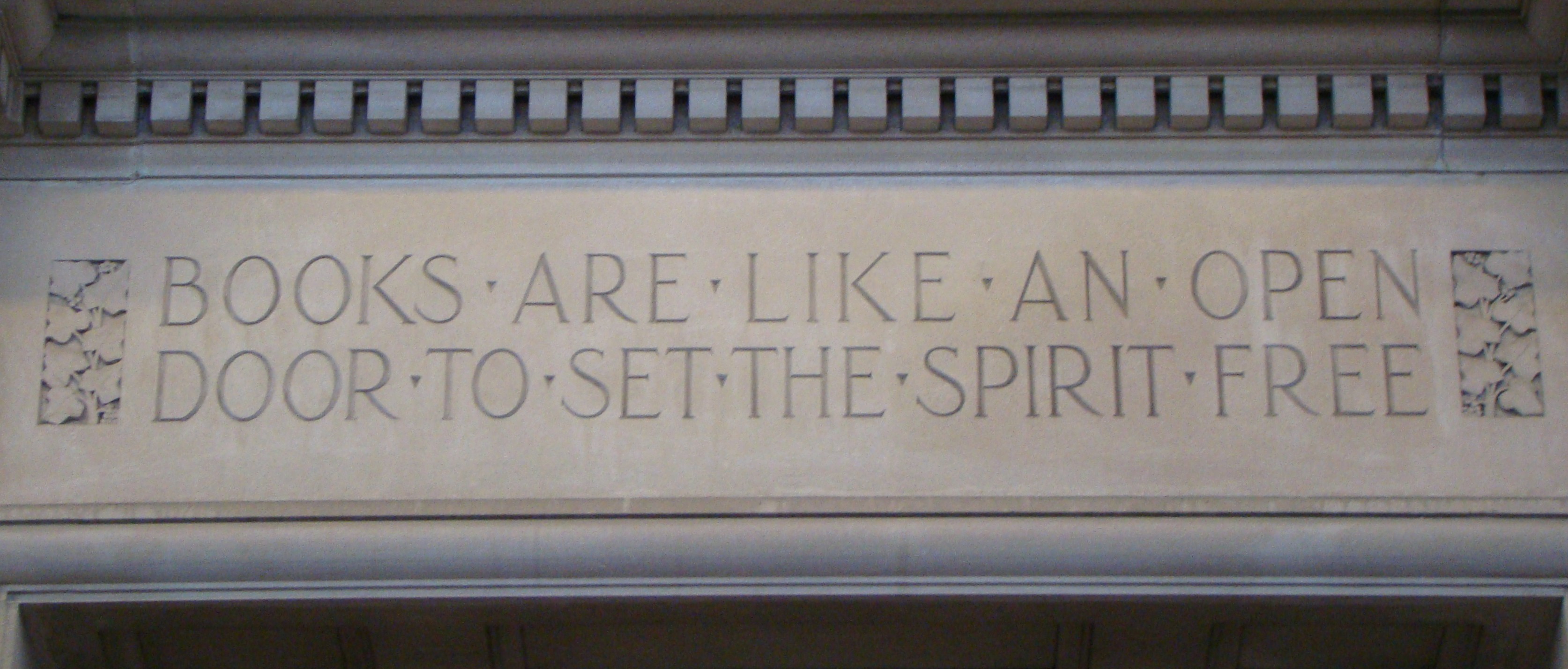 Inscription on building that reads "Books are like an open door to set the spirit free"