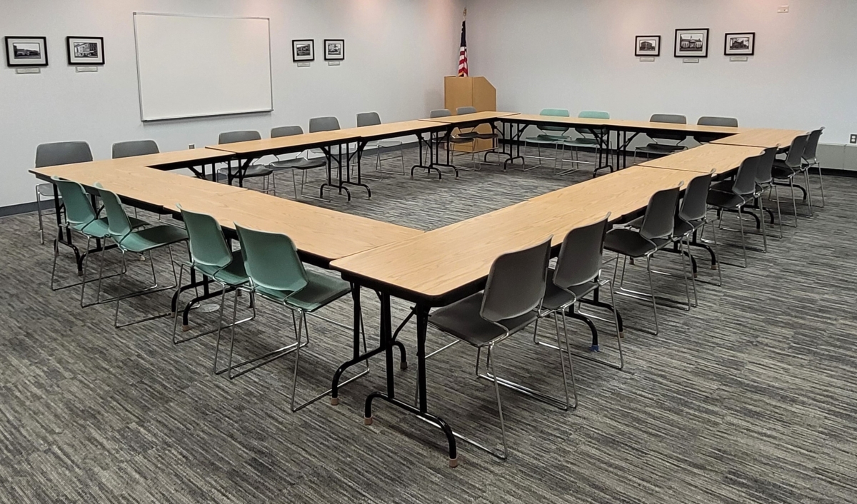 Tables arranged in an enclosed square with chairs on outside of square
